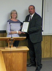 Wild Iris Executive Director Lisa Reel receives Domestic Violence Proclamation from Bishop Mayor Jim Ellis.